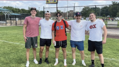 Charles Mule stands with his brothers in their Theta Chi letters at East Brunswick Managers Complex for a wiffle ball charity.