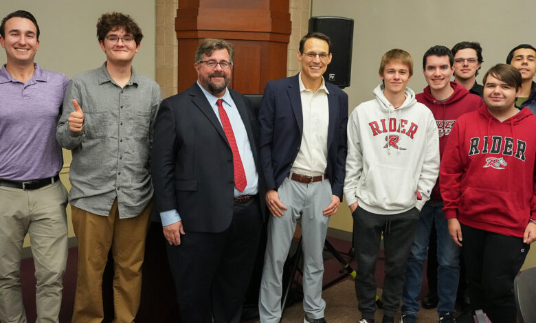 Micah Rasmussen and Steve Kornacki stand with students at a Rebovich event.