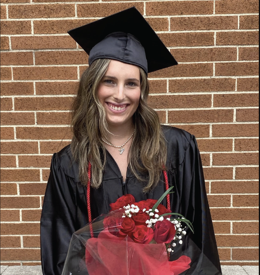 Freshman marketing major Brianna Bogos poses with roses at her high school graduation.