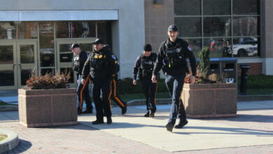 Police officers walk from the Student Recreation Center