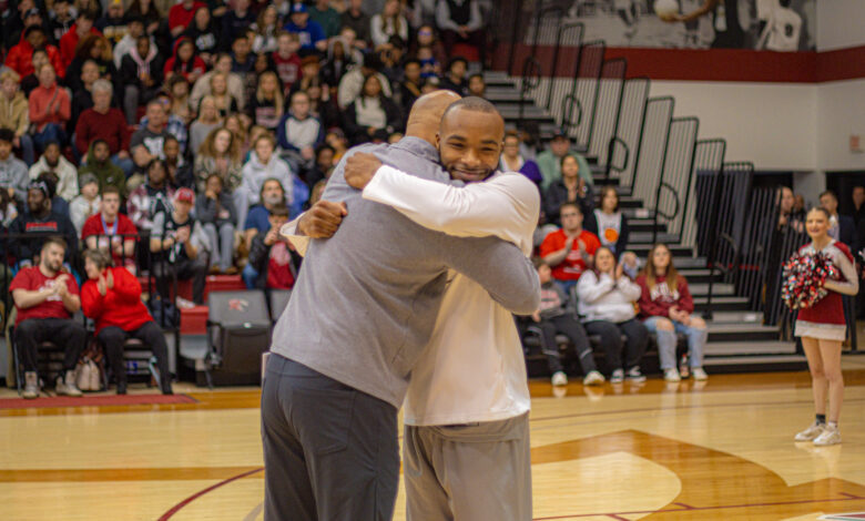 Head Coach Kevin Baggett (left) hugs senior guard Dwight Murray Jr. (right) on Senior Night.