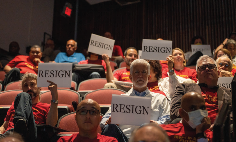 Members of the AAUP hold up signs urging Rider President Gregory Dell’omo to resign as he spoke at the faculty and staff convocation.