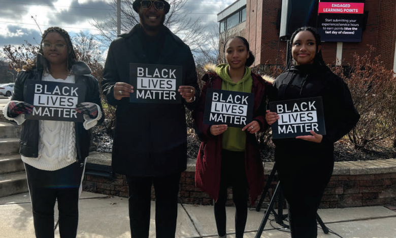 Executive board members of Rider's Black Student Union hold Black Lives Matter signs at the flag raising. From left to right: Faith Robinson-Hughes, a sophomore film and television major, Naa'san Carr, a junior public relations major, Corrine Walton-Macaulay, a junior health science major and Kayla McIntyre, a junior global studies major.