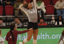 Senior outside hitter Jenna Amaro launches to sail the ball over the net.