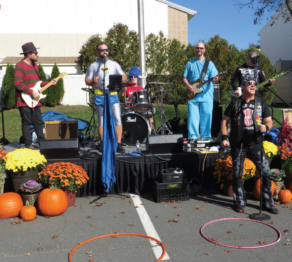The band Amp'd performs at the Homecoming Tailgate. 
It played a mixture of tunes from the '70s, '80s and some newer hits. 
The attendees sang and danced along to the music. 