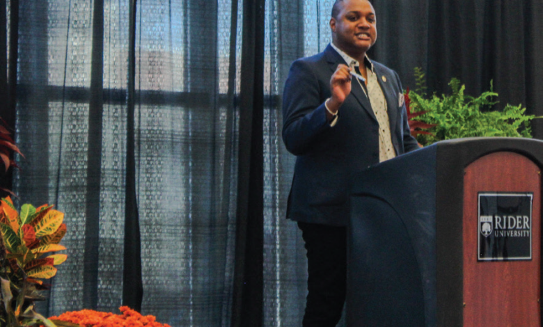 Award-winning journalist Ernest Owens spoke to the Rider community surrounded by an array of fall florals.
