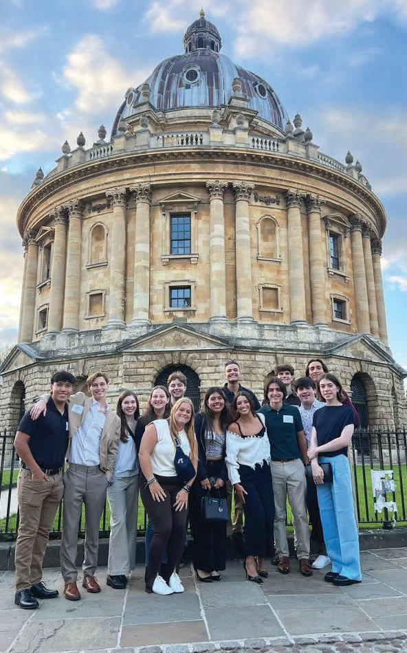 Students take a photo in front of the Radcliffe Camera in Oxford,
England