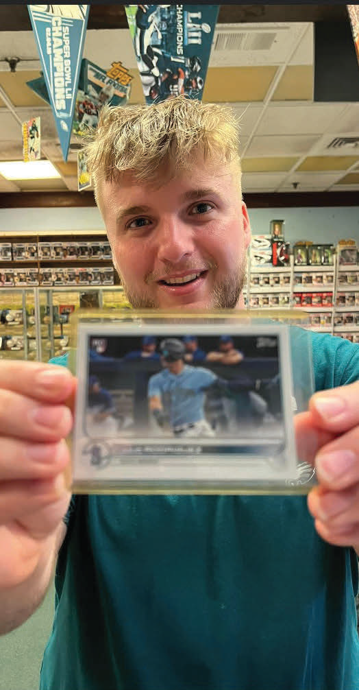 Andrew Coates a senior communication studies major poses with a
baseball card he flipped. The card sold for $391.70 on eBay.