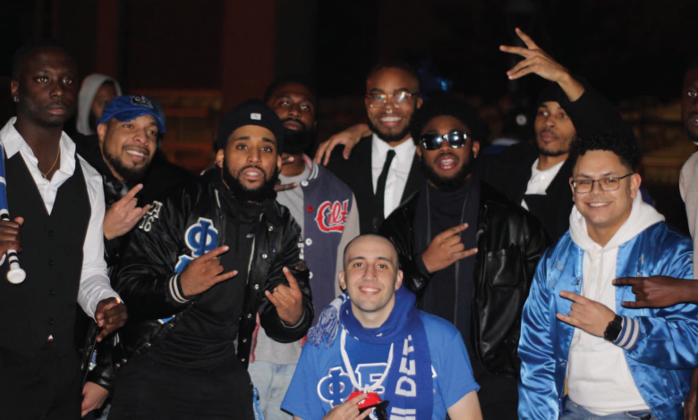 Approvato (front center) smiles for a photo with Phi Beta Sigma Fraternity Inc. as a new member.