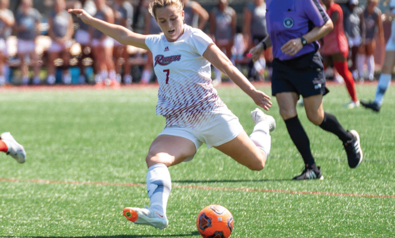 Graduate student forward Chloe Fisher loads up to kick the ball down the field.
