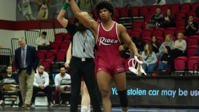 Senior Azeem Bell celebrates as he wins his final home bout by major decision. Maggie Kleiner/The Rider News