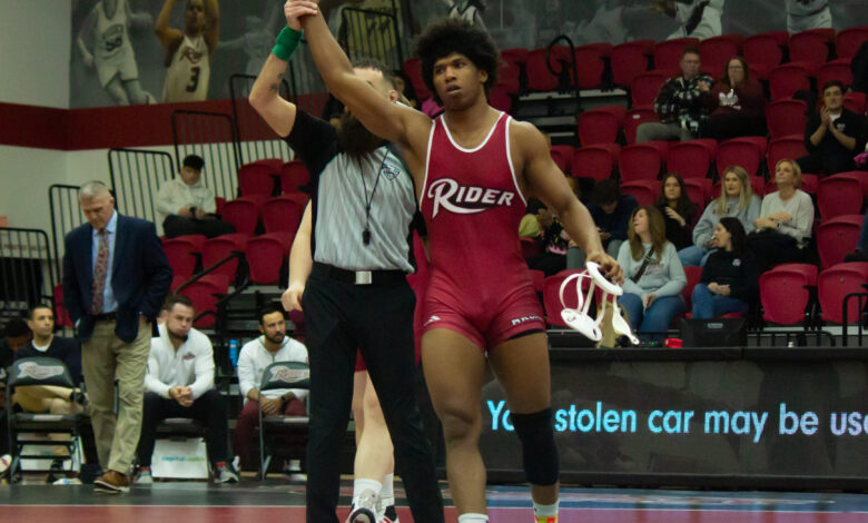 Senior Azeem Bell celebrates as he wins his final home bout by major decision. Maggie Kleiner/The Rider News