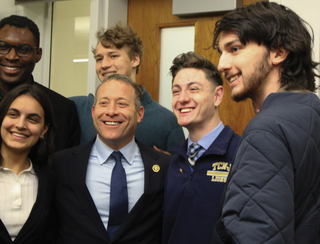 Congressman Josh Gottheimer poses with students after the event.