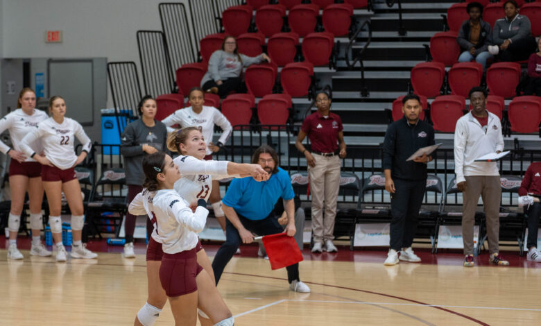 Sophomore libero Simone Langford (left) watches as sophomore libero Carly Zimmet (right) serves up the ball.