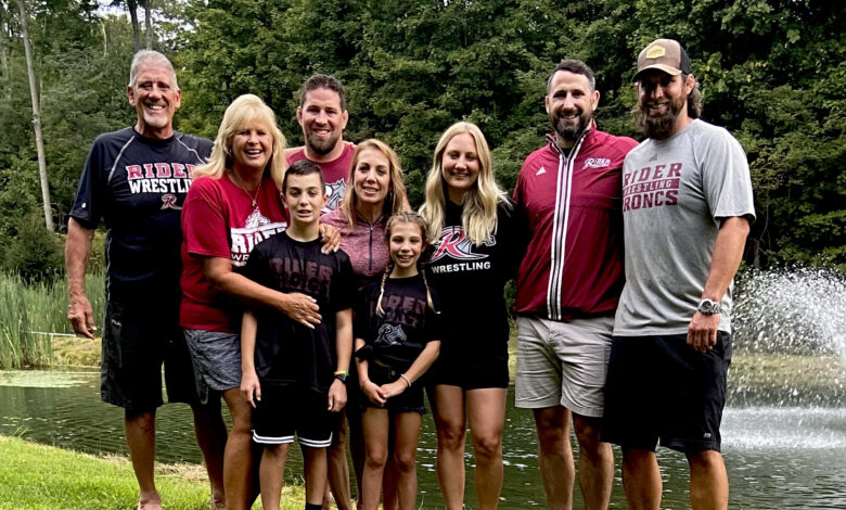 Tim Morrison (left) stands with his family, all repping Rider wrestling.