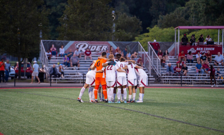 The Broncs huddle up on the field before their match.