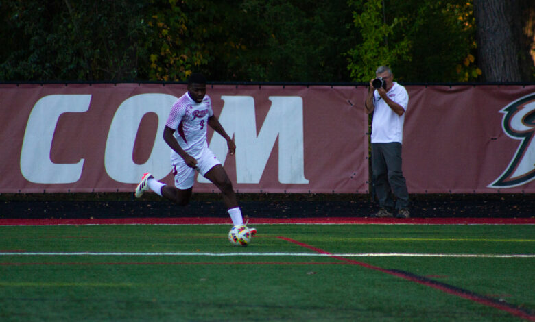 Senior midfielder Bryan Okongo dribbles the ball up the field. Photo by Destiny Pagan