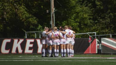 The Broncs huddle up on Ben Cohen Field. Photo by Destiny Pagan