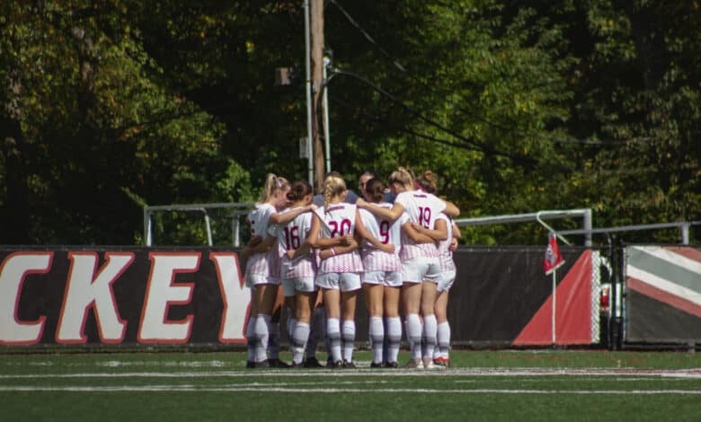 The Broncs huddle up on Ben Cohen Field. Photo by Destiny Pagan