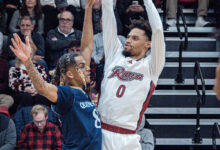 Junior guard Zion Cruz rises above the defender to shoot a jump shot. Photo by Josiah Thomas/The Rider News