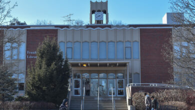Students walk in front of the Franklin F Moore Library.
