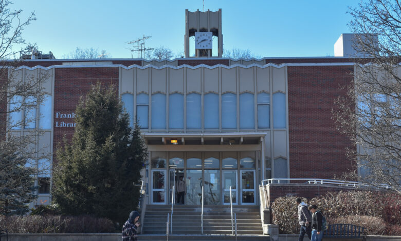 Students walk in front of the Franklin F Moore Library.