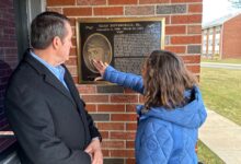 Julie and Gary DeVercelly visit a plaque outside Lake House honoring their son who died as a result of hazing.