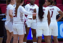 The Broncs huddle up on the court during a timeout. Photo by Destiny Pagan