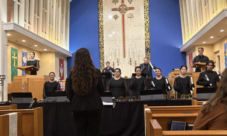 Professor Gillian Erlenborn conducts the Westminster Handbell Choir I as two students sing while the rest ring their bells.