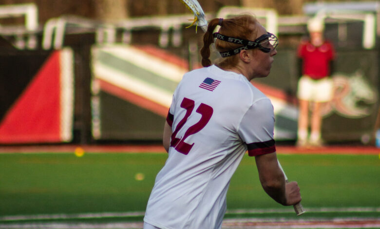 Graduate student Anna Devlin races up the field, stick in hand. Photo by Destiny Pagan