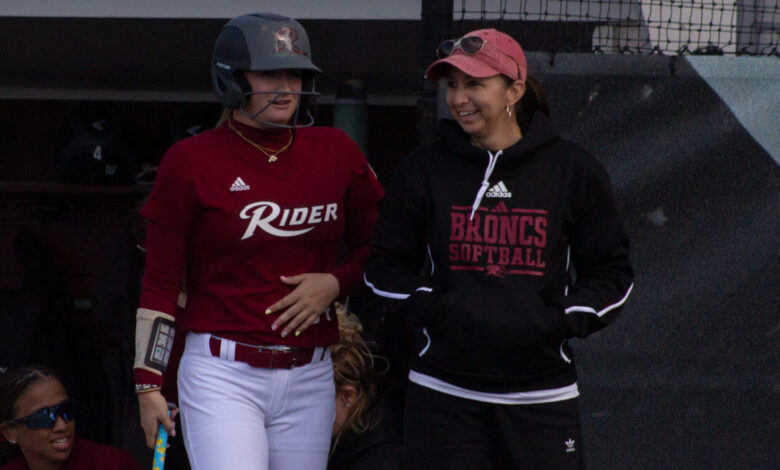 Junior outfielder Fallyn Stoeckel (right) waits on-deck with Head Coach Davon Ortega (right). Photo by Destiny Pagan