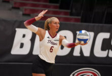 Senior middle blocker Molly Rohde preparing to serve. Photo courtesy of Peter G. Borg